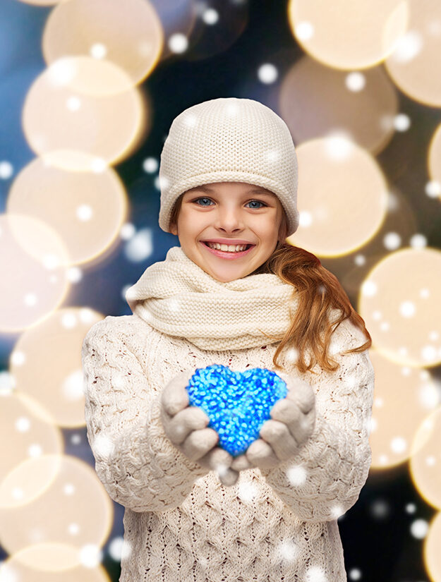 charity happiness love concept smiling teenage girl winter clothes with small red heart e1668565566654