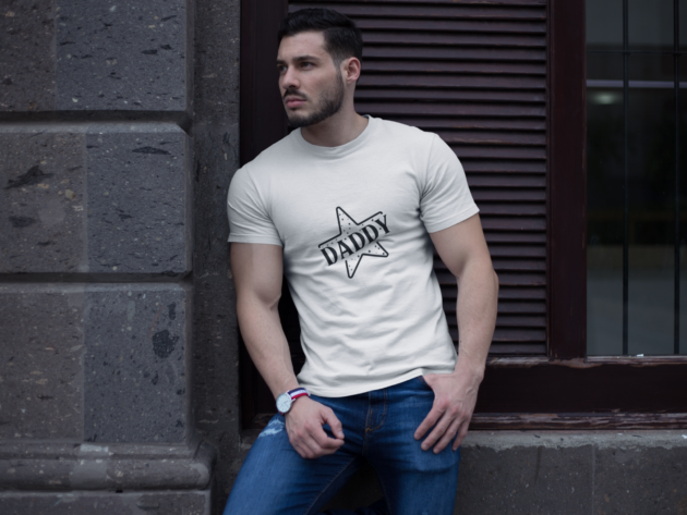 buff man wearing a t shirt mockup while lying against a wall a17659 1