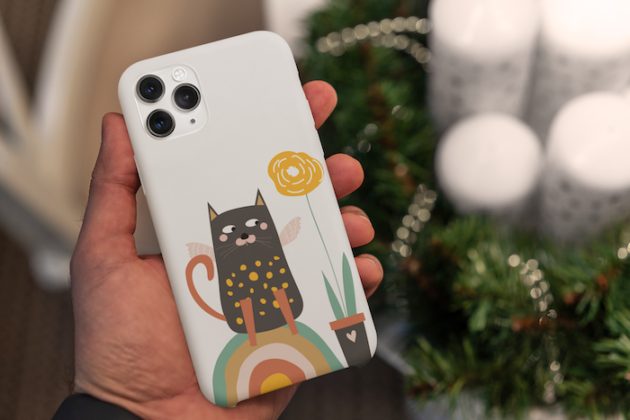 christmas themed mockup of a man holding a phone case 5173 el1