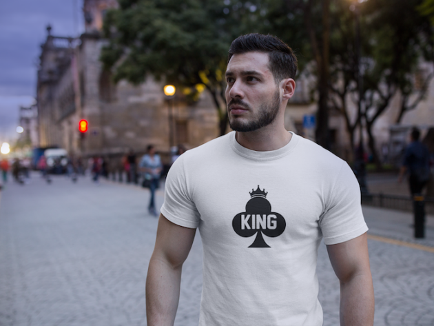 handsome buff man wearing a round neck t shirt mockup while walking on the boulevard a17686