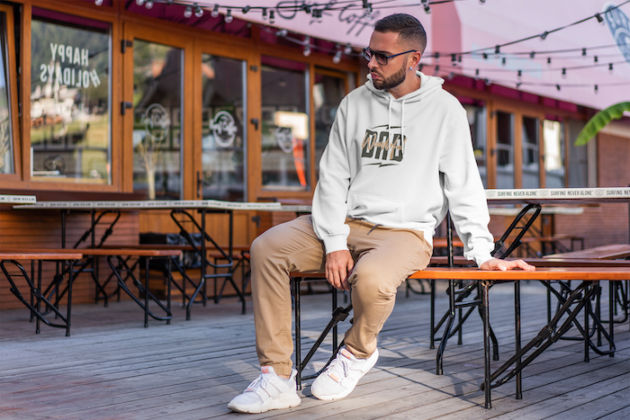 hoodie mockup of a serious man sitting at an open air restaurant 2276 el1