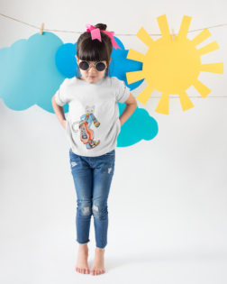 little girl wearing a tshirt mockup making faces against cardboard clouds and sun a19479 1