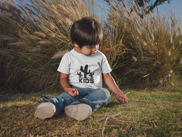 little kid wearing a t shirt mockup at a park a20192