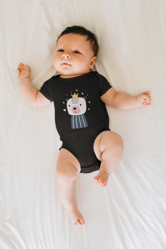 mockup of a baby wearing a onesie and laying on a white sheet m10815 r el2 4
