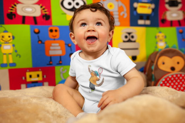 mockup of a joyful baby boy smiling wearing a onesie 14027