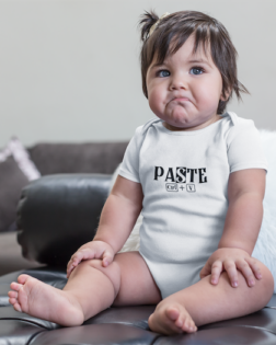 mockup of a sad baby girl wearing a onesie sitting on a leather couch a14049
