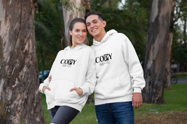 mockup of a smiling couple wearing matching hoodies at the park 30754