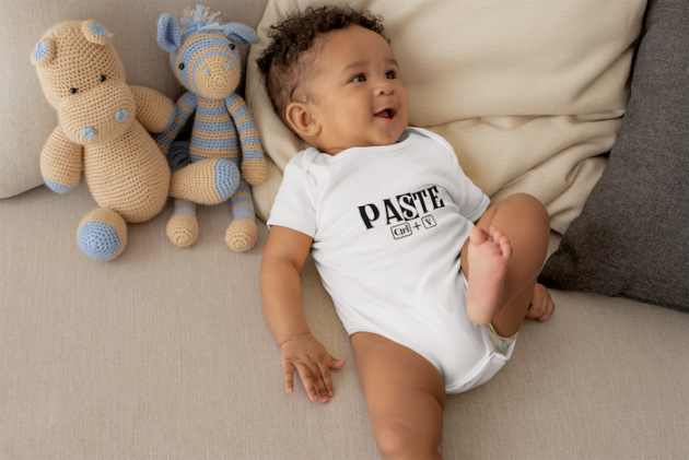 onesie mockup of a cute baby boy lying in bed with stuffed animals 25121