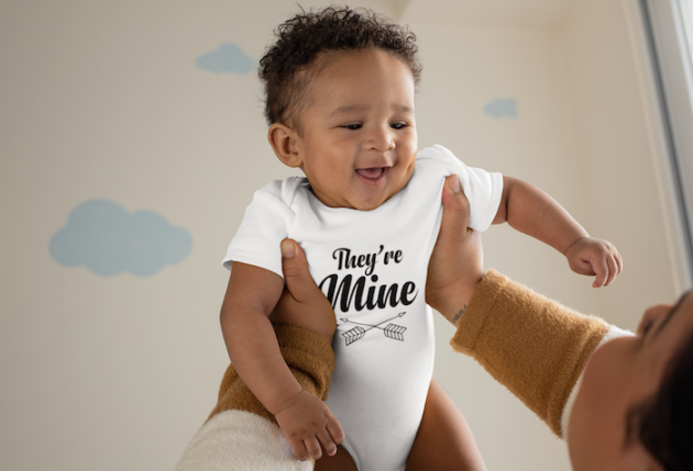 onesie mockup of a joyful baby being lifted by his mother 25120 2