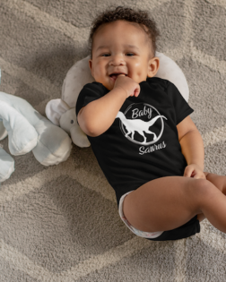 onesie mockup of a sweet baby boy with dimples next to his stuffed toys 25115 5