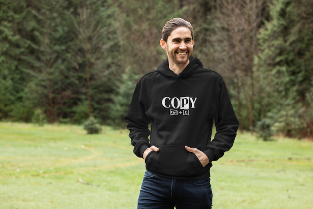 pullover hoodie mockup of a smiling man in an open green area 25103