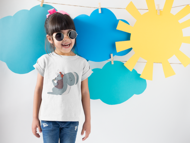 smiling girl wearing a round neck tshirt template near cardboard sun and clouds a19480