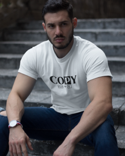 strong dude wearing a t shirt mockup while sitting on stairs a17660