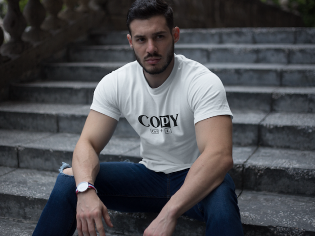 strong dude wearing a t shirt mockup while sitting on stairs a17660