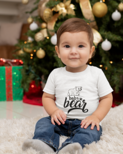 t shirt mockup featuring a baby boy sitting by a christmas tree m1008 1