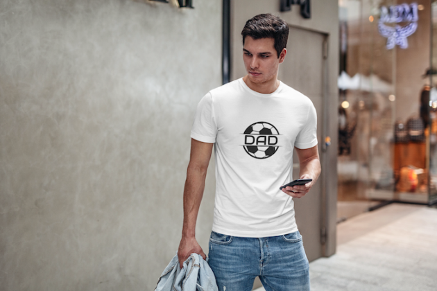 t shirt mockup featuring a young man by a store checking his phone 425 el 1
