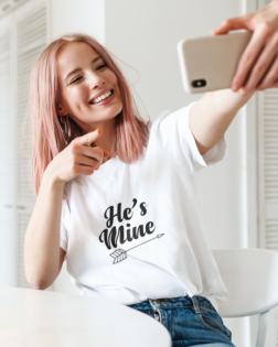 unisex t shirt mockup featuring a woman with pink hair taking a selfie 44785 r el2
