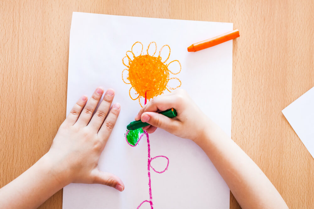 child-drawing-orange-flower
