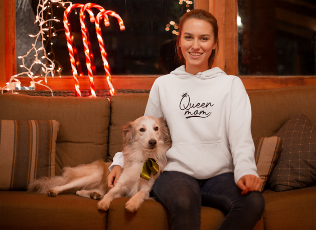 christmas hoodie mockup of a woman surrounded by xmas ornaments with her dog 23520
