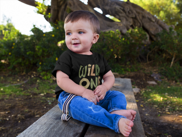 cute baby boy sitting down in a wooden bench while wearing a round neck tshirt template a16088 1