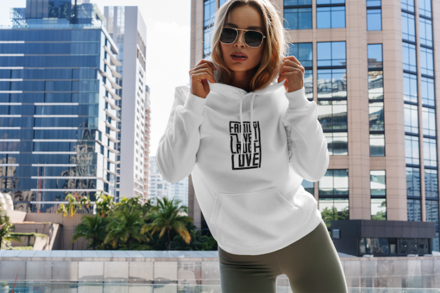 hoodie mockup featuring a woman posing and some buildings in the background 3550 el1 1
