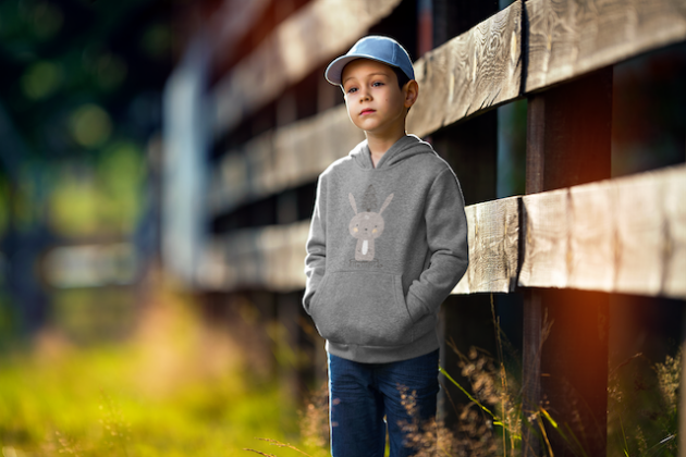 hoodie mockup of a boy standing by a fence 2928 el1