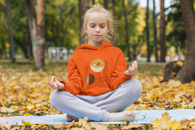 hoodie mockup of a little girl meditating at a park m18018 r el2 1