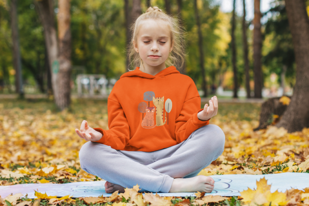 hoodie mockup of a little girl meditating at a park m18018 r el2