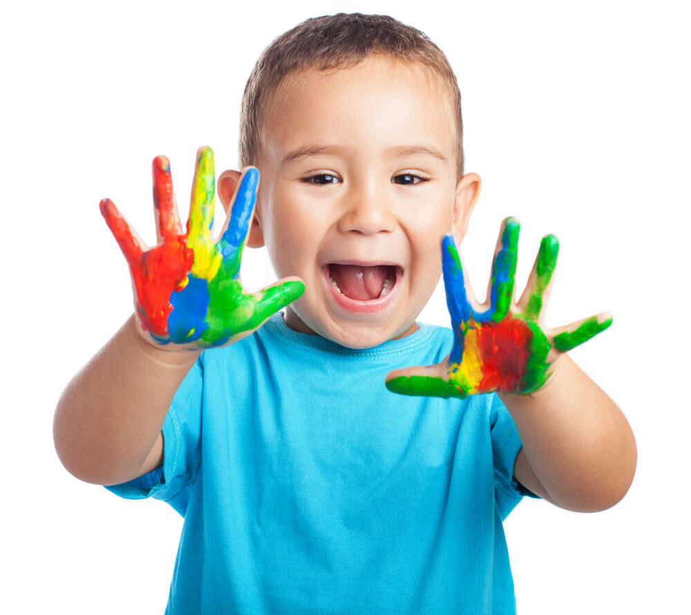 little boy with hands full paint with open mouth