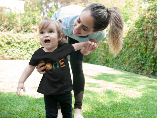 mockup of a smiling baby girl wearing a t shirt with her mom a16097