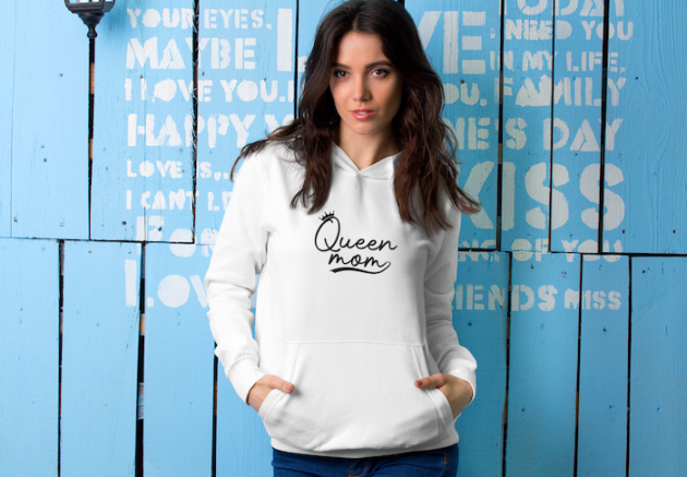 mockup of a woman wearing a hoodie while posing against a wall 5309 el1