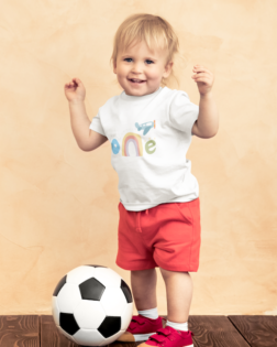 t shirt mockup of a toddler standing by a soccer ball 43080 r el2